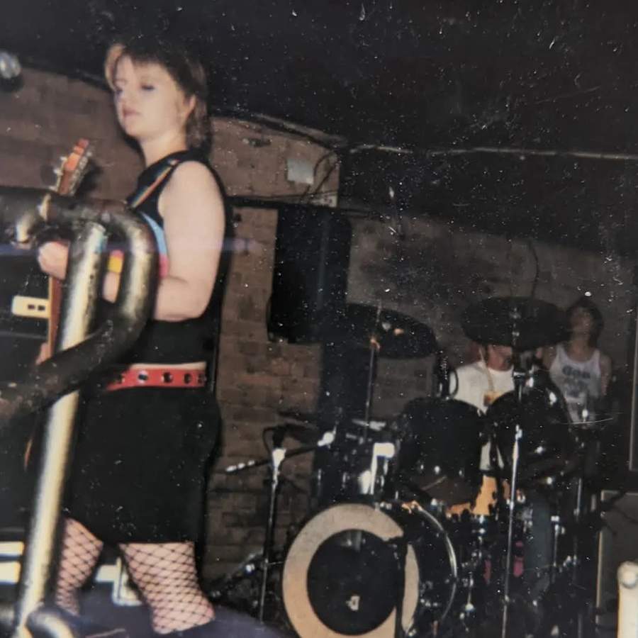 Nicci playing bass on stage in a band, London, 2003.